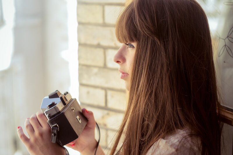 woman holding vintage camera
