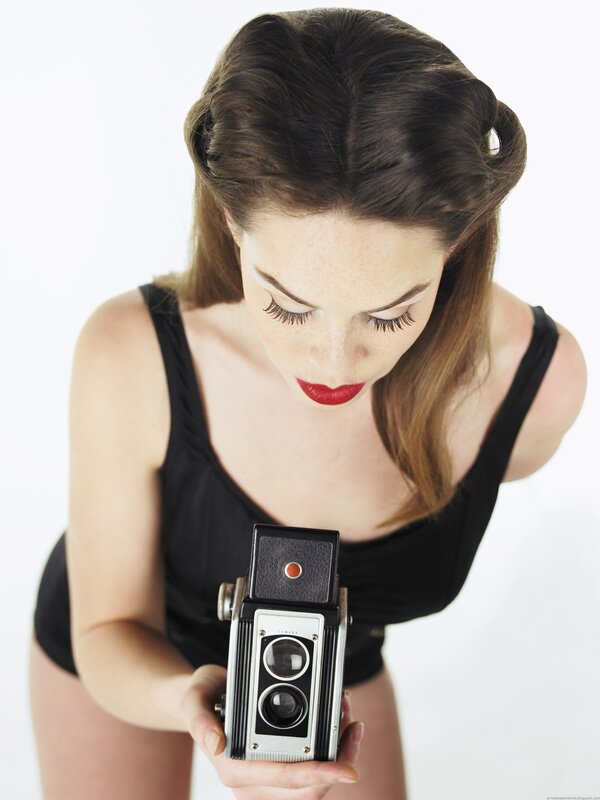 woman holding vintage camera