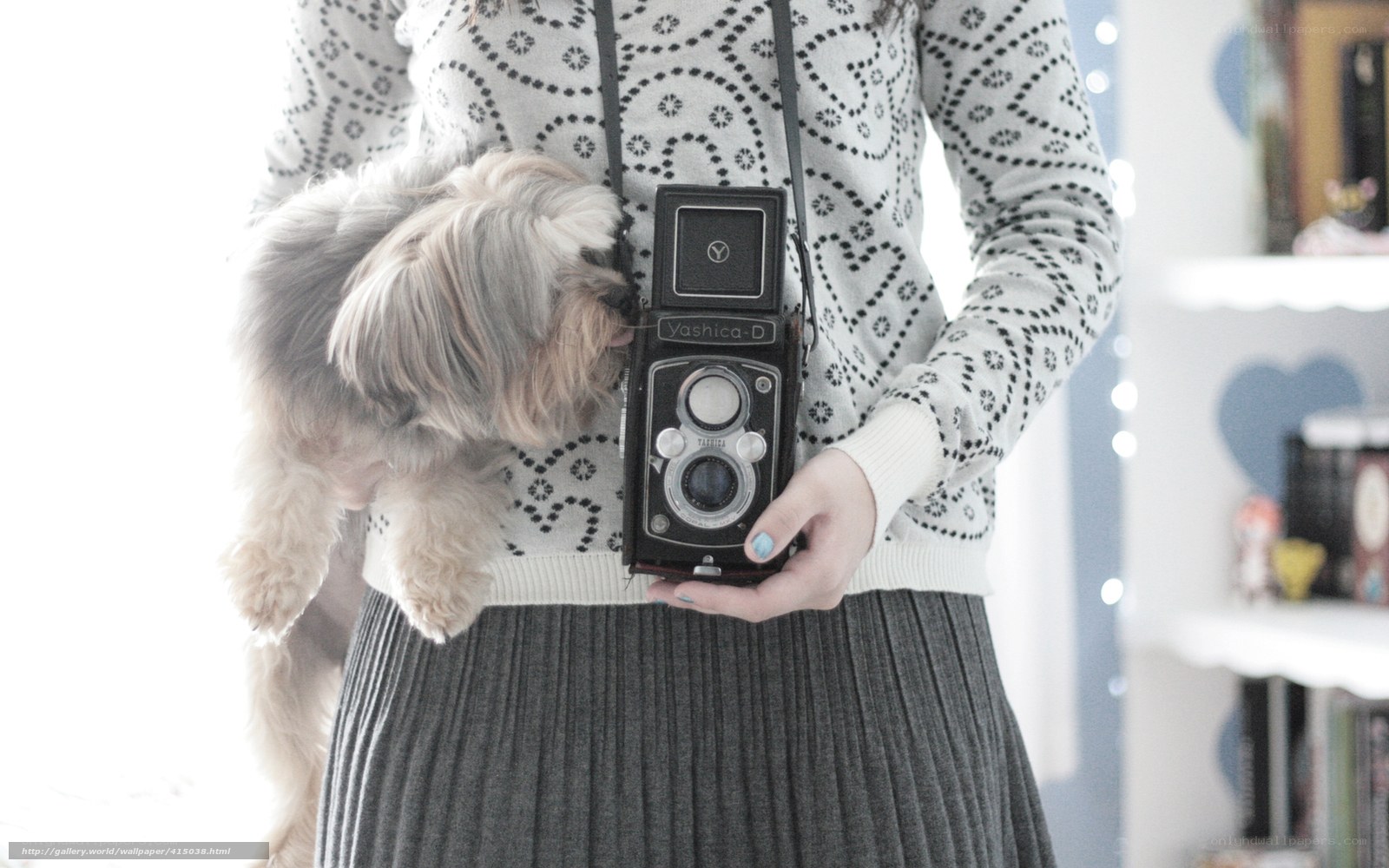 woman holding vintage camera with dog