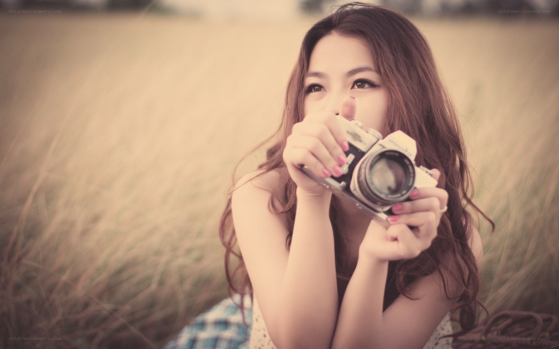 woman holding vintage camera