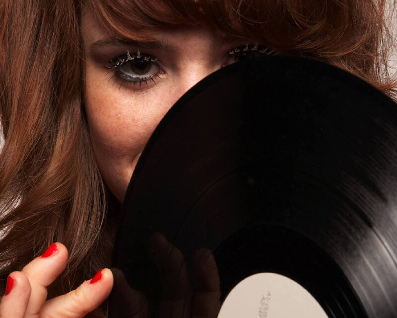 woman holding vinyl record