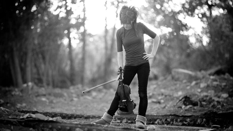 woman holding violin in forest