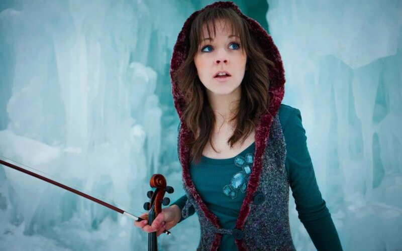 woman holding violin in ice cave