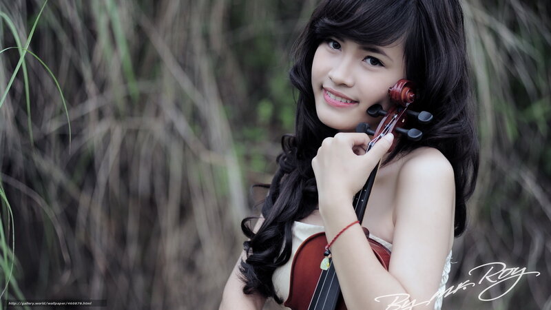 woman holding violin outdoors