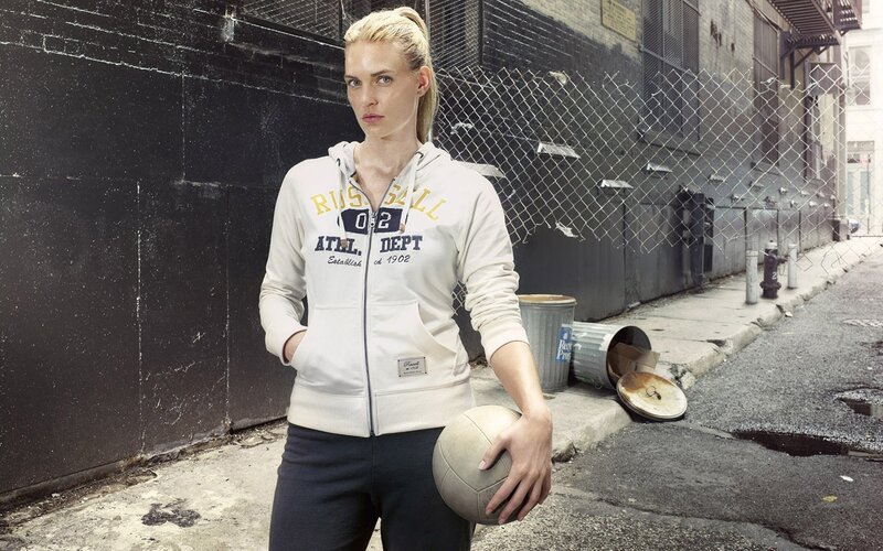 woman holding volleyball in alley
