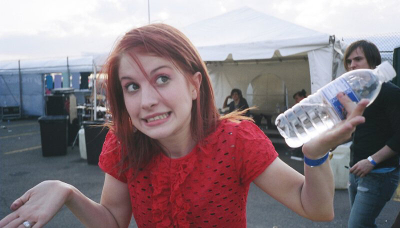 woman holding water bottle at event