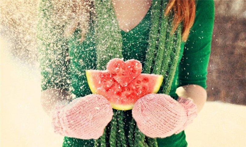 woman holding watermelon in snow