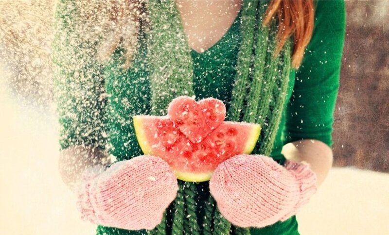 woman holding watermelon in snow