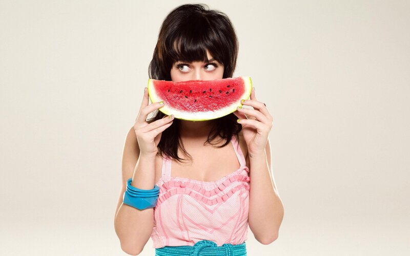 woman holding watermelon slice