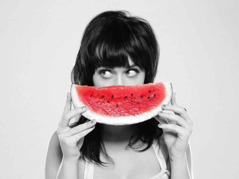 woman holding watermelon slice