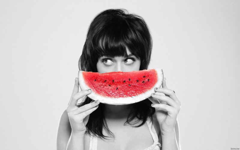 woman holding watermelon slice
