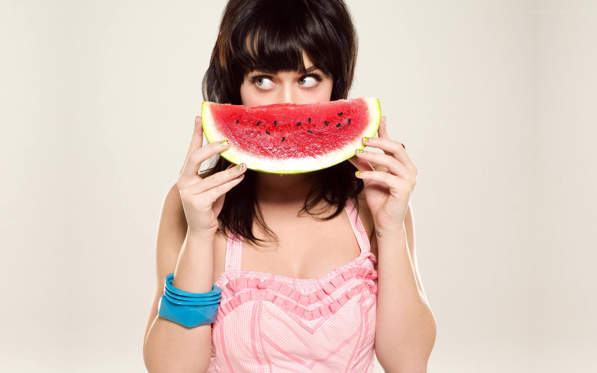 woman holding watermelon slice