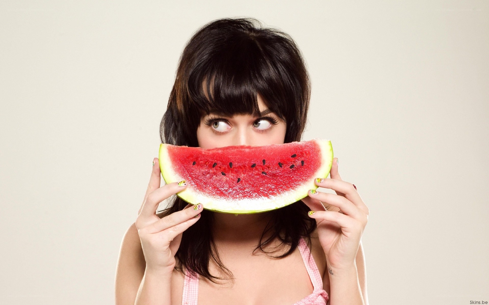 woman holding watermelon slice