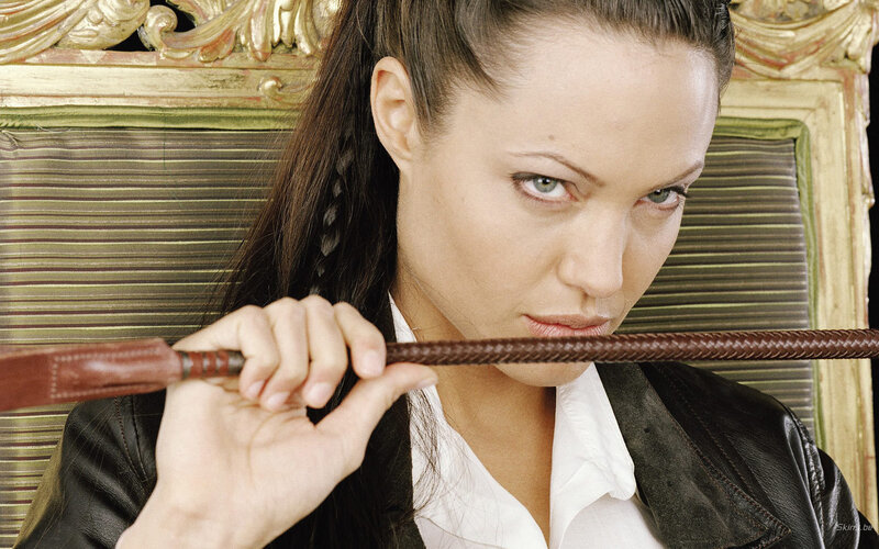 Woman Holding Whip — Brown