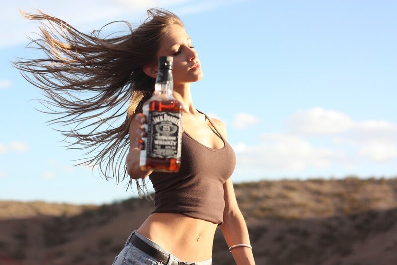 woman holding whiskey bottle