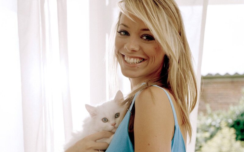 woman holding white cat