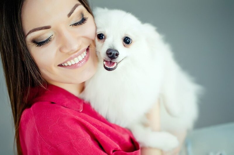 Woman Holding White Dog — Happy