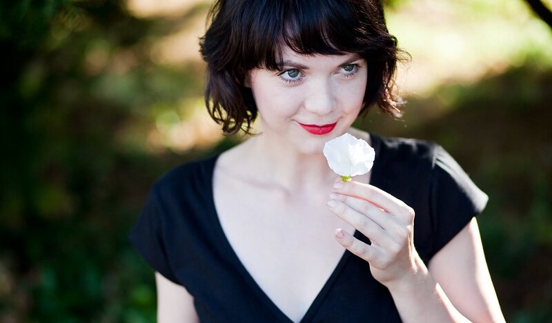 woman holding white flower