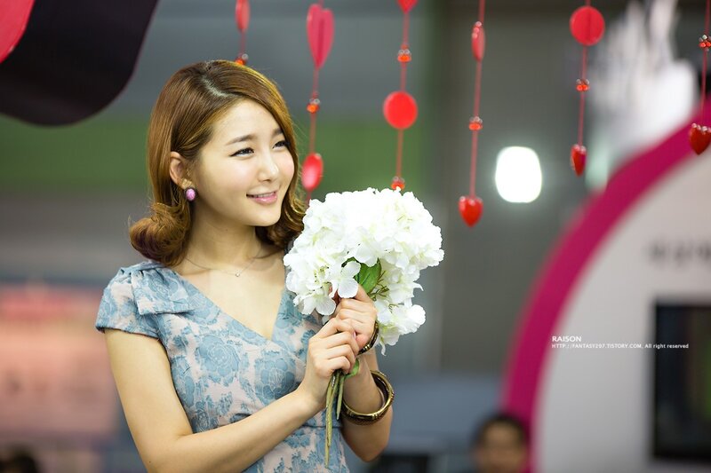 woman holding white flowers