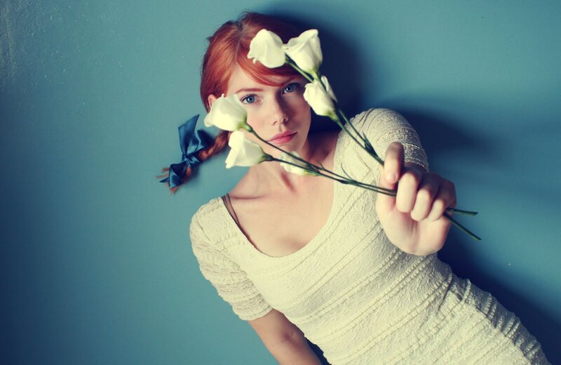 woman holding white flowers
