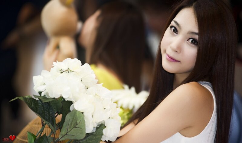woman holding white flowers