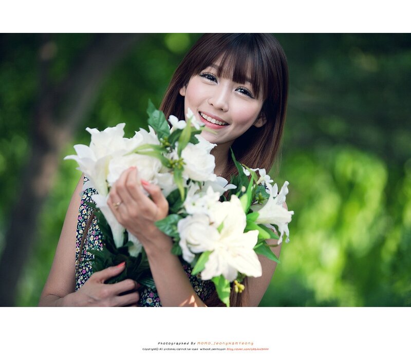 woman holding white flowers