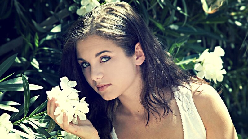 woman holding white flowers