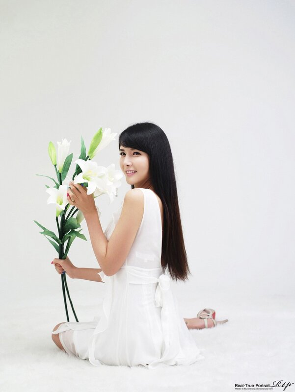 woman holding white lilies