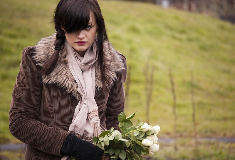 woman holding white roses