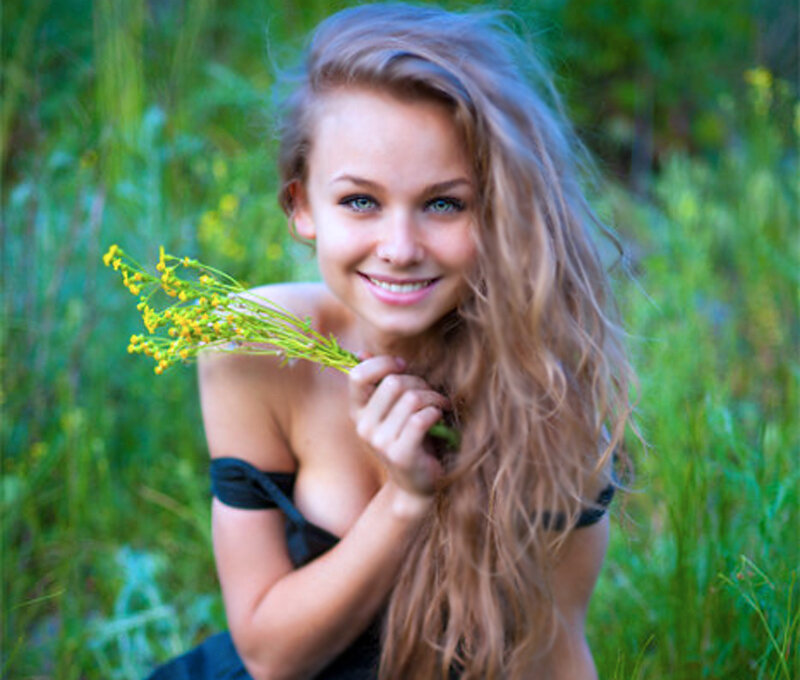 Woman Holding Wildflowers — Green