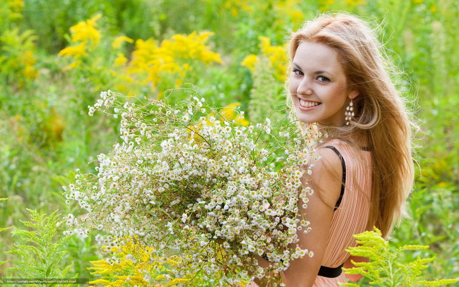 Woman holding wildflowers in field