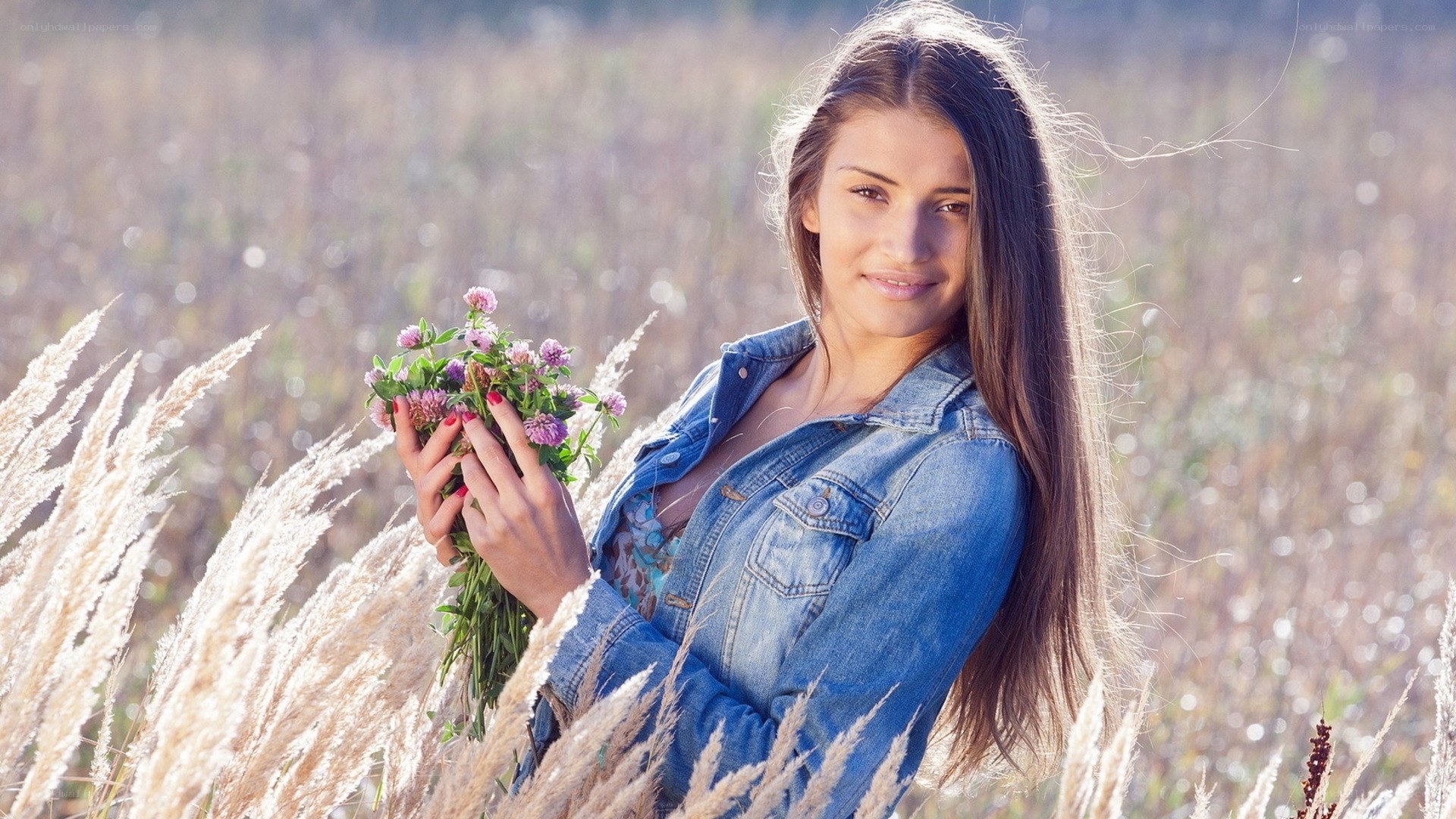 woman holding wildflowers in field