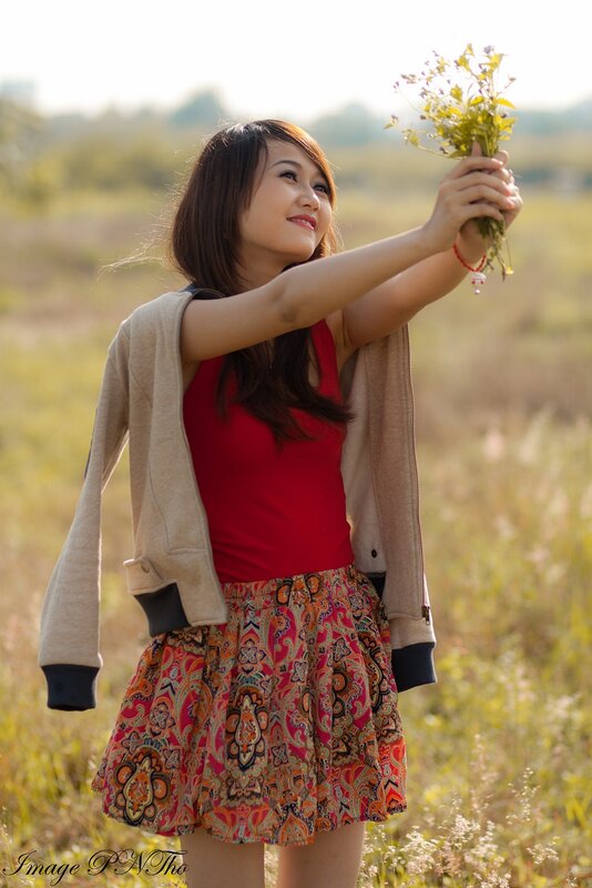 Woman Holding Wildflowers — Red, Serene