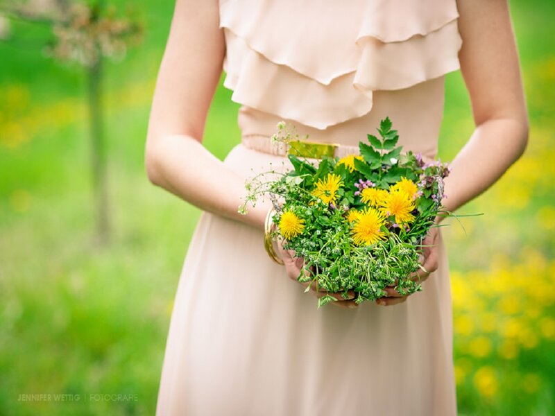 Woman Holding Wildflowers — Yellow