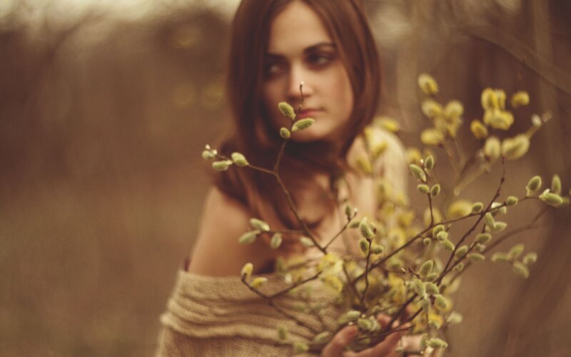 woman holding willow branches