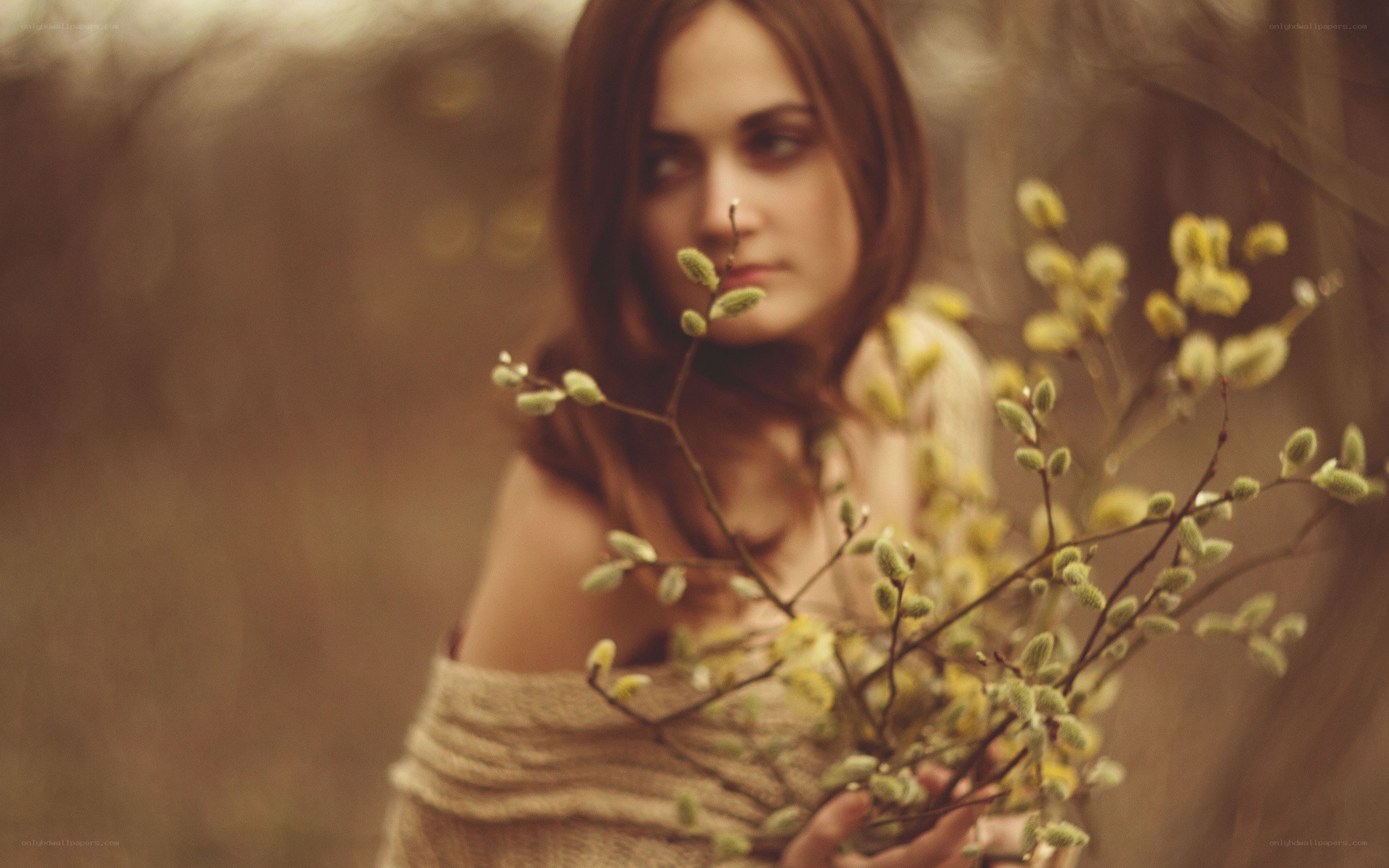 woman holding willow branches