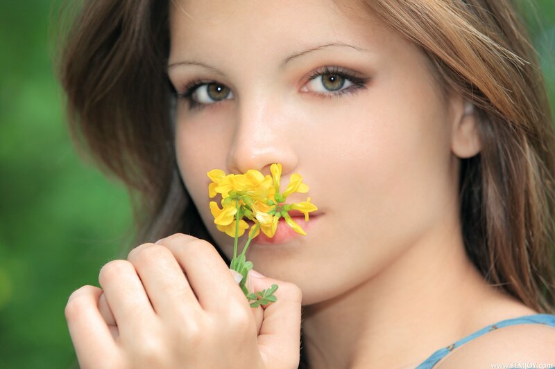 woman holding yellow flower