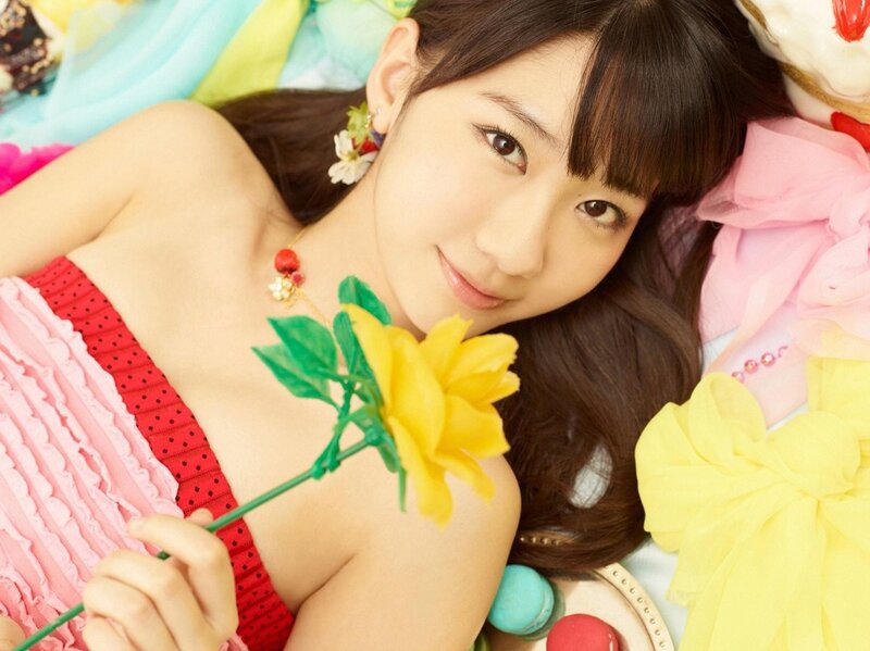 woman holding yellow flower