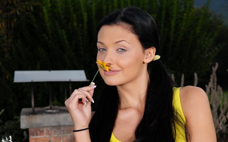 woman holding yellow flower