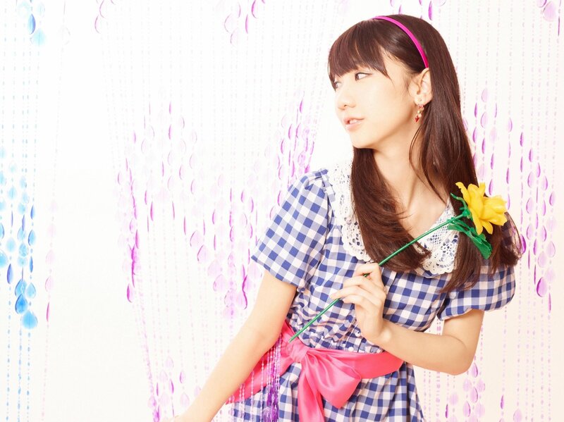 Woman Holding Yellow Flower — Blue, Playful, Photograph