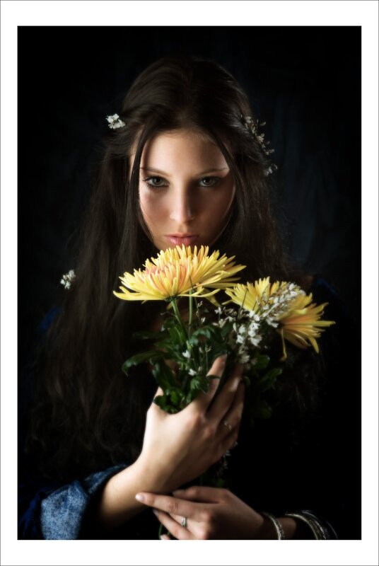 woman holding yellow flowers