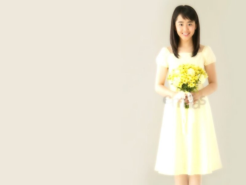 woman holding yellow flowers