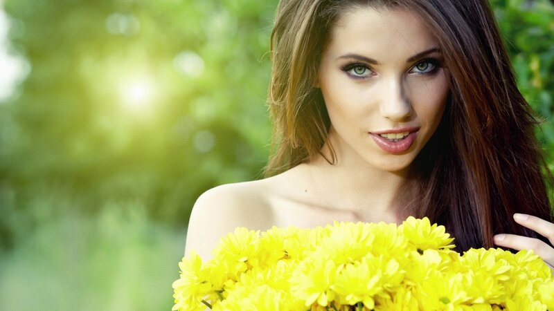 woman holding yellow flowers