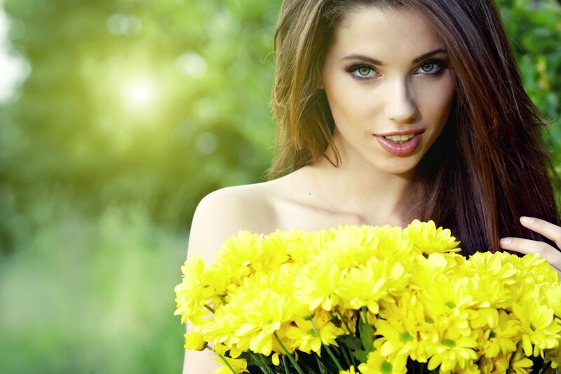 woman holding yellow flowers