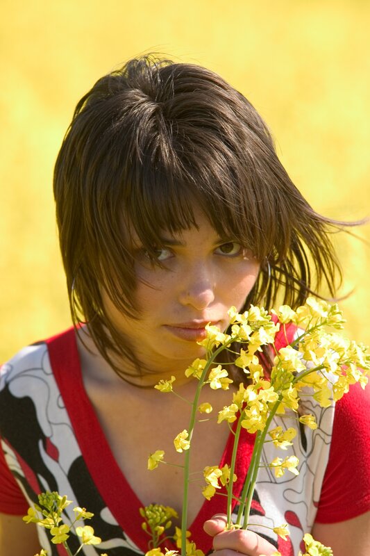 woman holding yellow flowers