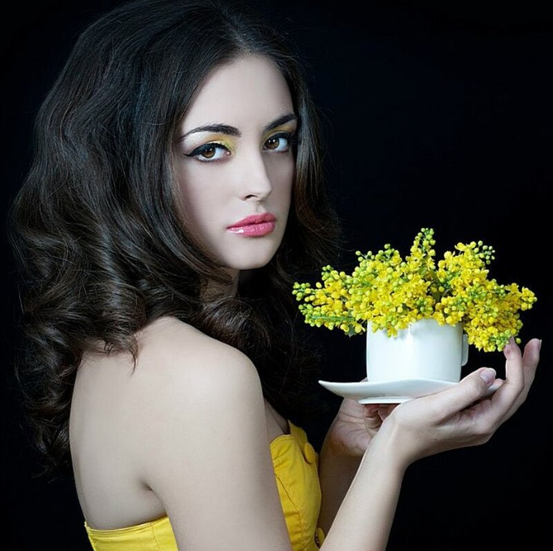 Woman Holding Yellow Flowers — Dramatic