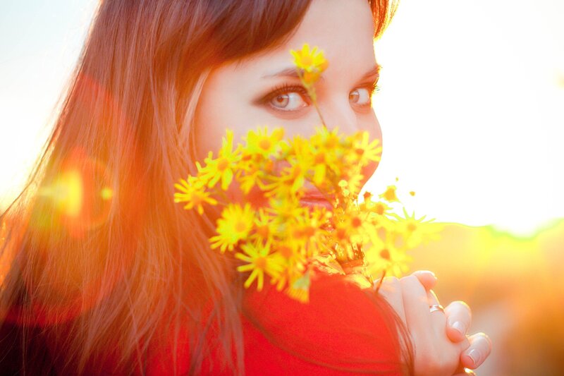 Woman Holding Yellow Flowers — Serene, Sunset, Photograph