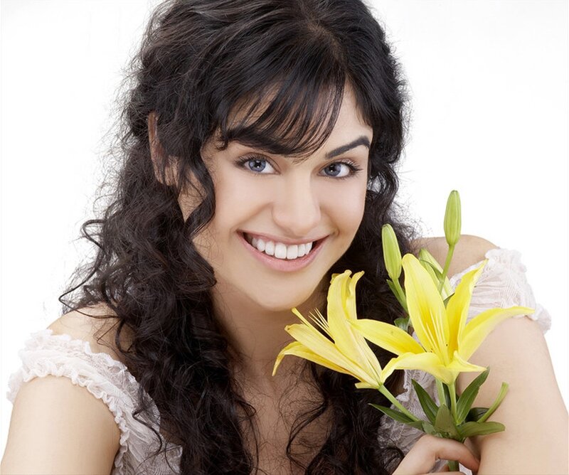 woman holding yellow lilies
