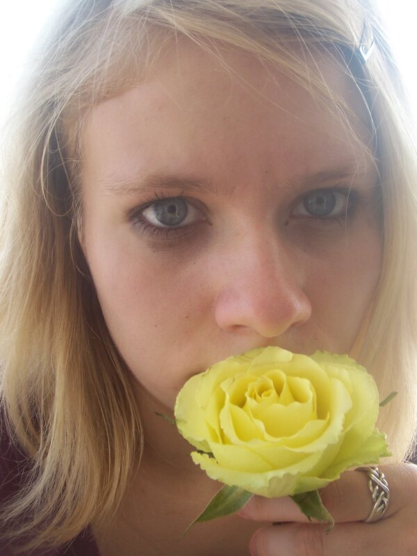 woman holding yellow rose