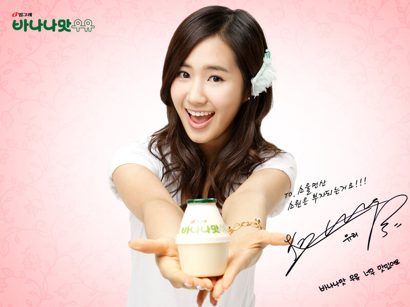 woman holding yogurt bottle